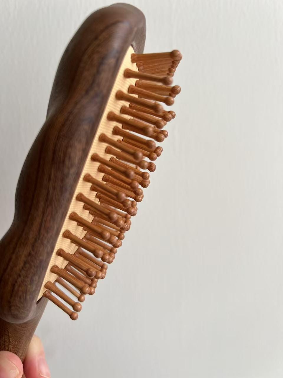 Close-up of wooden bristles – gentle detangling and scalp meridian massage feature of Joy Garden Hair Growth Brush