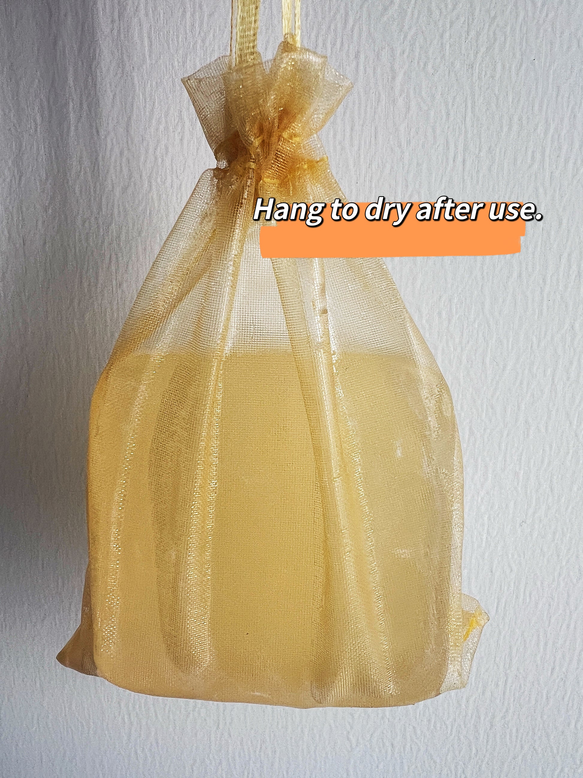 Joy Garden Hinoki Silk Protein Facial Soap hanging in net to air dry naturally