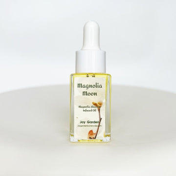 Joy Garden Magnolia Blossom Face Oil 10ml: A 100% botanical brightening elixir in a dropper bottle for a dewy glow and sensitive skin repair.