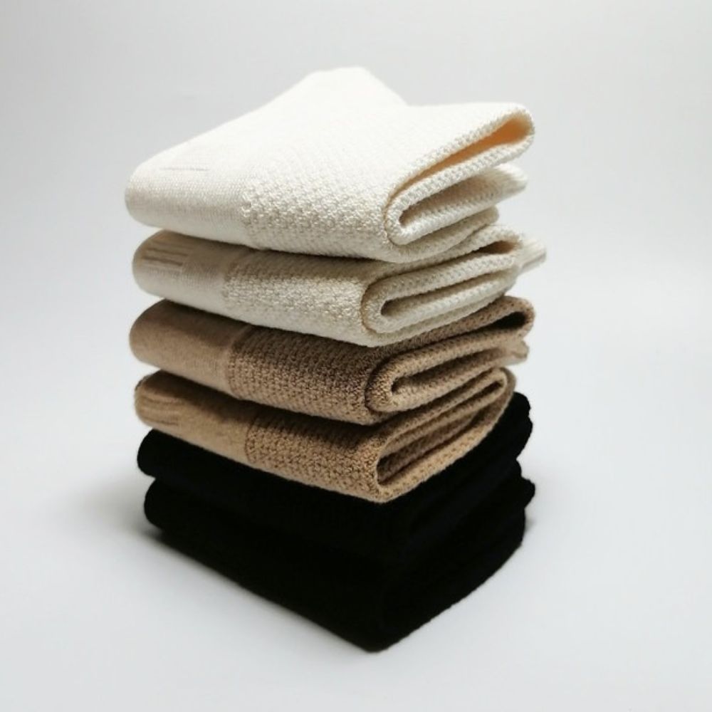 Trio of Joy Garden organic cotton socks in White, Beige, and Black color palette.