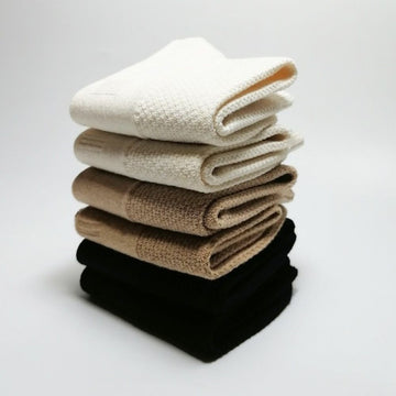 Trio of Joy Garden organic cotton socks in White, Beige, and Black color palette.